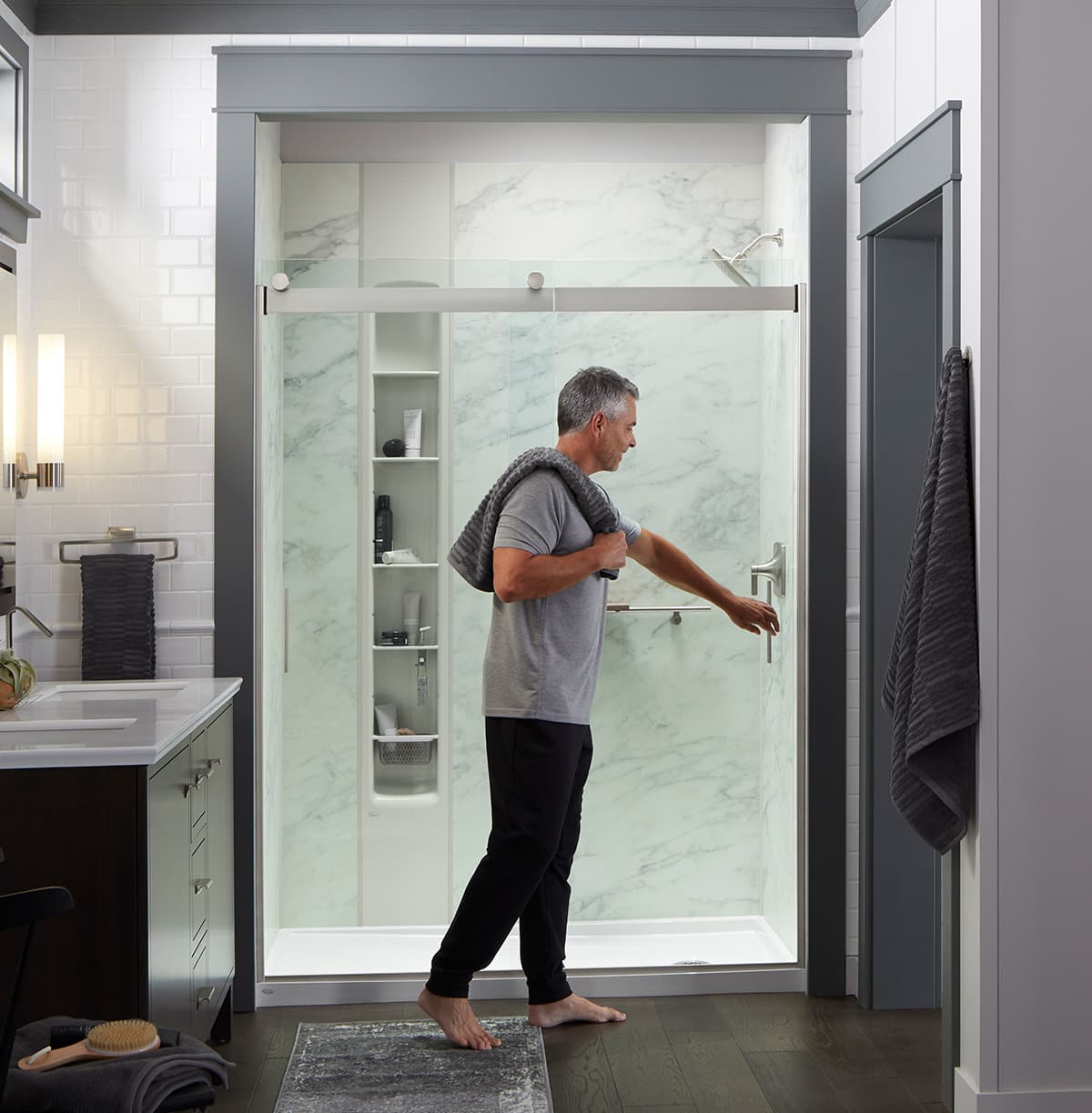 Man opening the slidding door of a LuxStone Shower